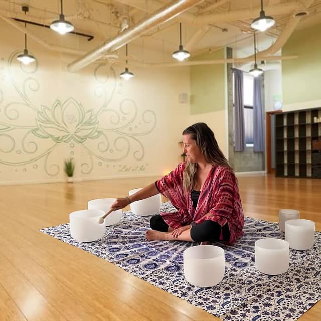 800x800 Sound meditation instructor playing crystal sound bowls during a group class