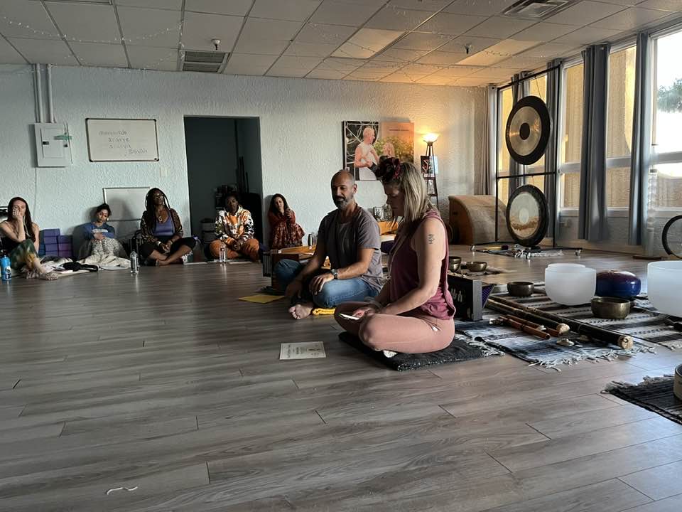 800x1080 Sound and yoga experience in a classroom with students sitting cross legged during a group session